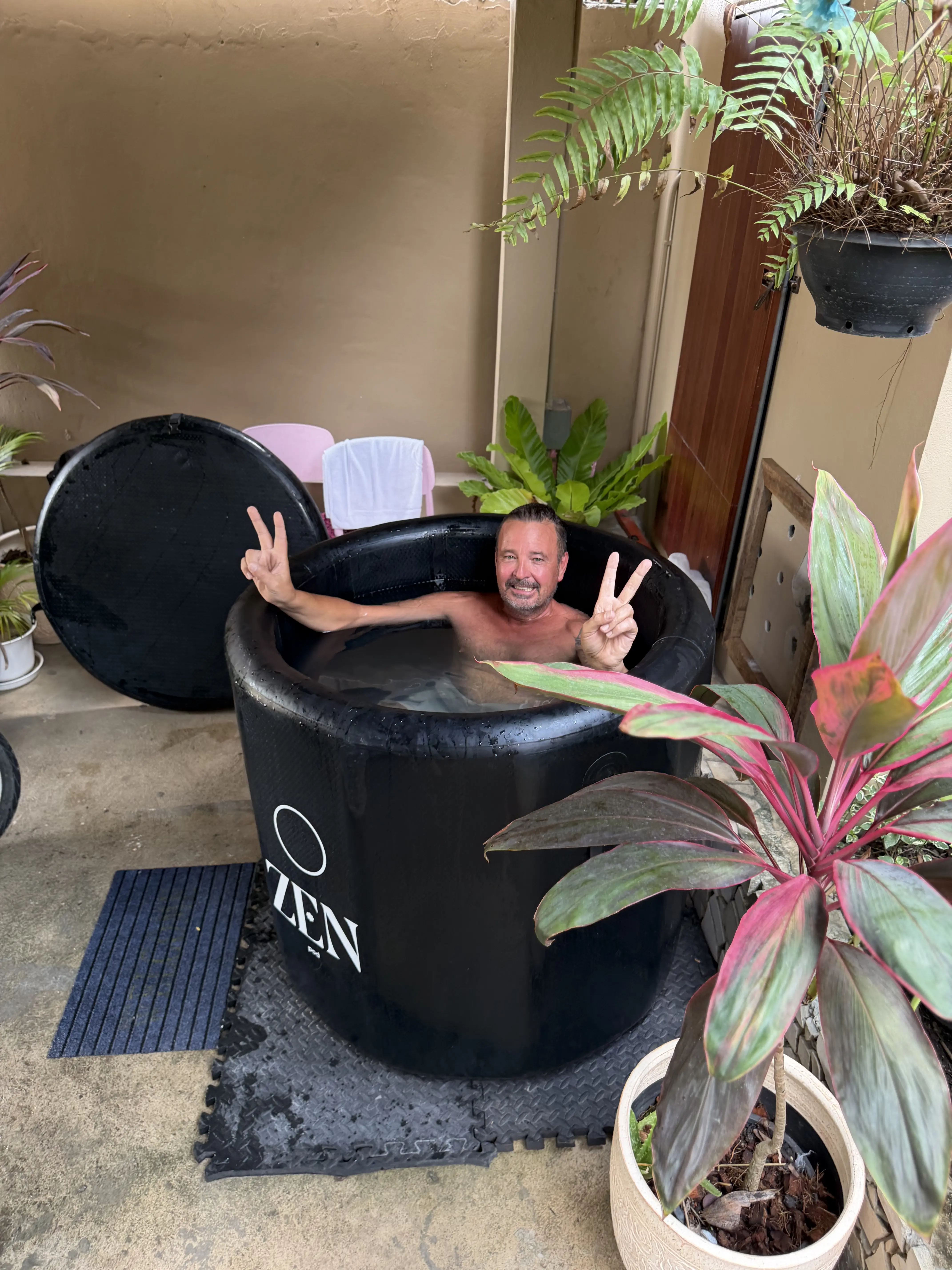 A guest in the Zen-branded portable ice bath tub
