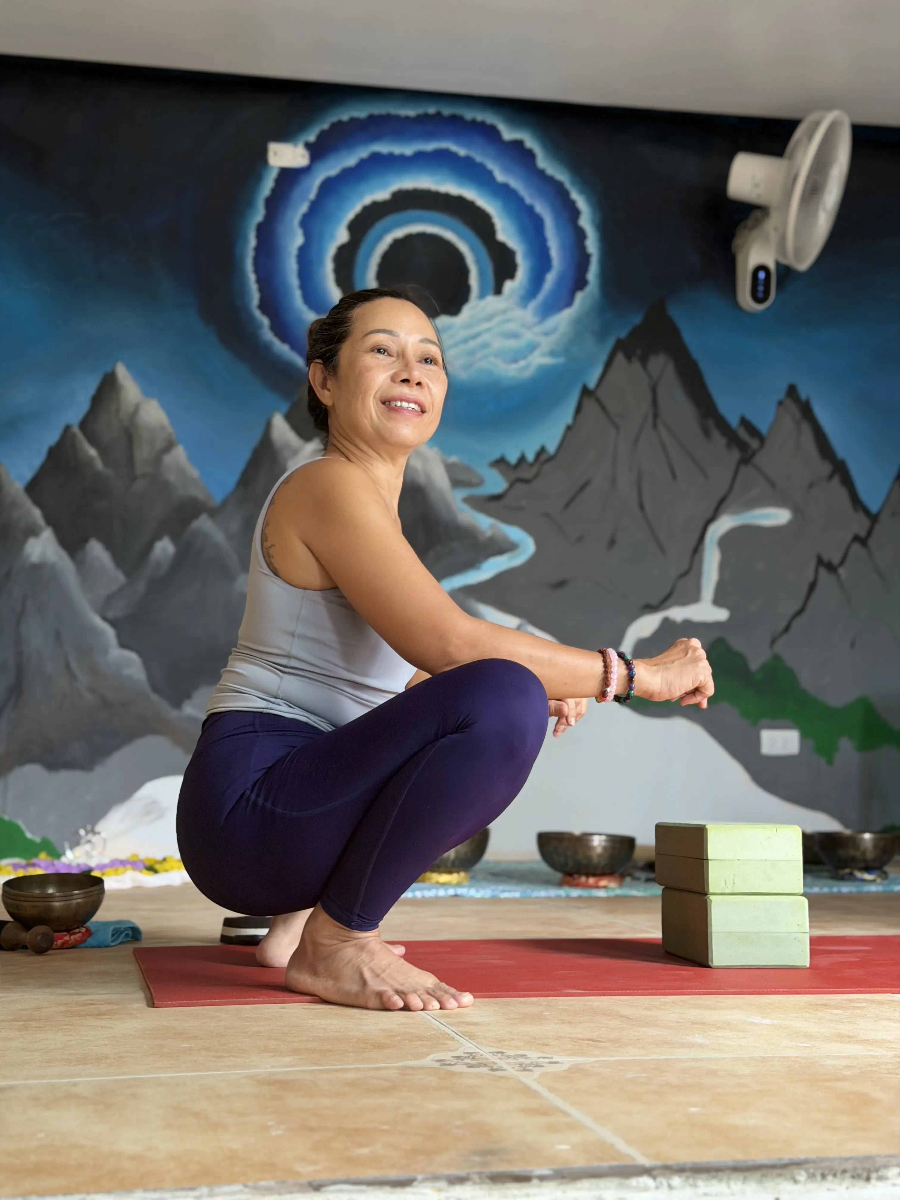 A yoga session in the Zen Pod studio, under the mountain mural