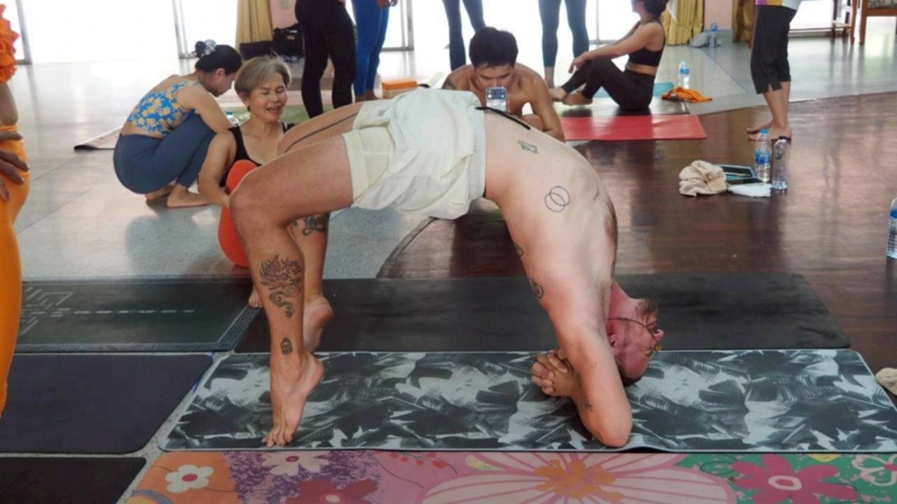 Nicklas practicing an inversion at a yoga workshop